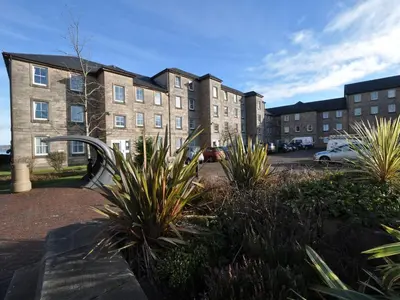 a building with a bunch of plants in front of it at The Waterfront in Greenock