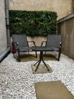 two chairs and a table in front of a building at Amani Apartments - Glasgow City Centre in Glasgow