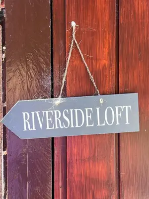 a sign that reads riverside lot hanging on a door at Riverside Loft in Barcaldine