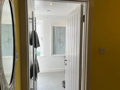 a bathroom with yellow walls and a mirror at St John's Town of Dalry Glentress Apartment 1 in Dalry