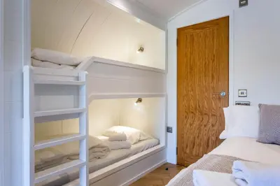 a bedroom with a bunk bed in a room at Kings Caves Glamping in Torbeg