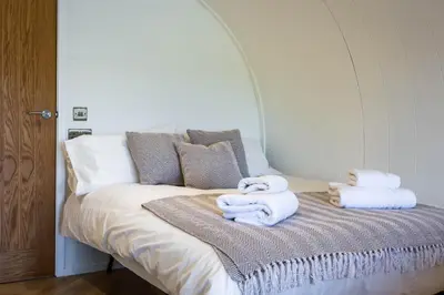 a bed with towels sitting on top of it at Kings Caves Glamping in Torbeg