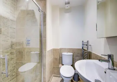 a bathroom with a shower and a toilet and a sink at Super central Edinburgh Castle basement in Edinburgh