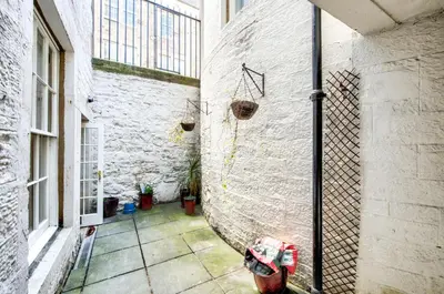 a hallway of a building with a fire hydrant on the wall at Super central Edinburgh Castle basement in Edinburgh