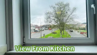 a view from a window of a street with a tree at 2 Bedrooms Entire Apartment Self Check in in Fife