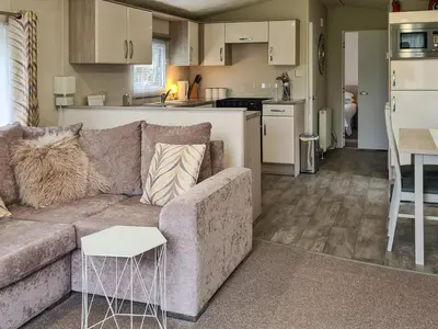 a living room with a couch and a kitchen at Castle Campbell View in Dollar
