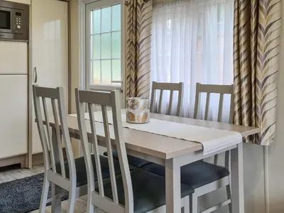 a kitchen with a wooden table and two chairs at Castle Campbell View in Dollar