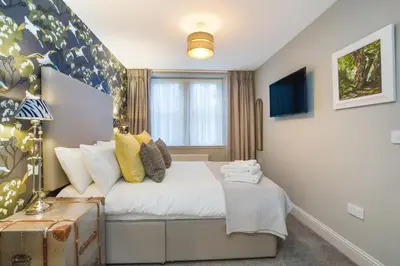 a small bedroom with a bed and a window at The Woodside in Doune