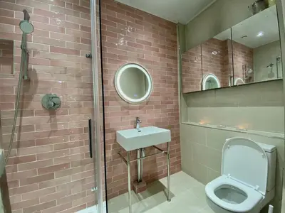 a bathroom with a toilet and a sink and a shower at Traveller Award Winner 2024 - Edinburgh Apartment with 3 Beds in Edinburgh