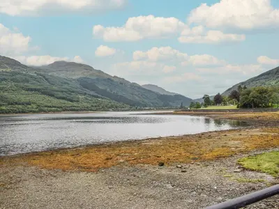 a body of water with mountains in the background at Beechwood in Arrochar