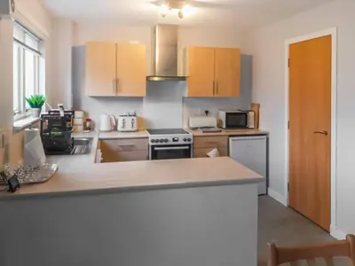 a kitchen with wooden cabinets and a counter top at Beechwood in Arrochar