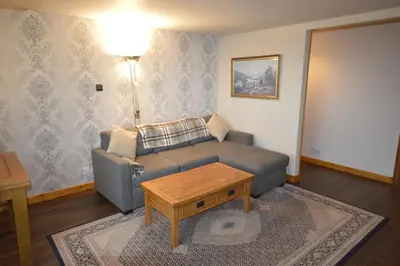 a living room with a couch and a coffee table at Ardura Apartment No 2 in Oban