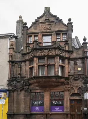 an old building on the corner of a street at George Street Apartment in Oban