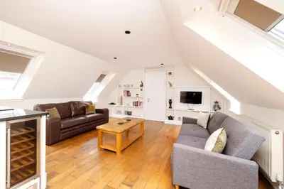 a living room with a couch and a table at JOIVY Lovely Flats near the City Centre in Edinburgh