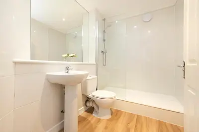 a bathroom with a toilet and a shower and a sink at JOIVY Lovely Flats near the City Centre in Edinburgh
