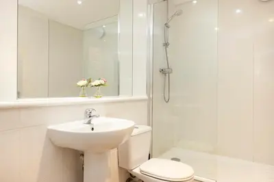 a bathroom with a sink and a toilet and a shower at JOIVY Lovely Flats near the City Centre in Edinburgh