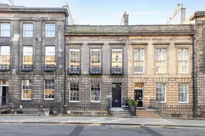 an old brick building with windows and a door at JOIVY 3BR Flat in Haymarket with Free Parking in Edinburgh