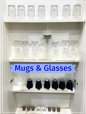 a shelf filled with glass jars and glasses at Spacious 3 Bedroom Entire Apartment Self Check in in Fife