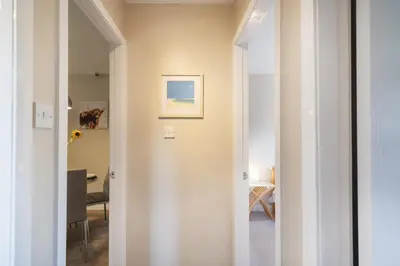 a hallway with a door leading to a dining room at The Kelvin - Peaceful West End River View Property in Glasgow