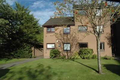 a house with a tree in front of it at The Kelvin - Peaceful West End River View Property in Glasgow