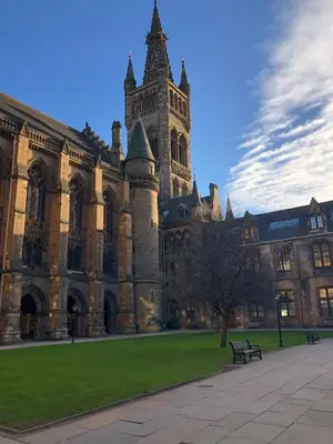 a large building with a clock tower in front of it at The Kelvin - Peaceful West End River View Property in Glasgow