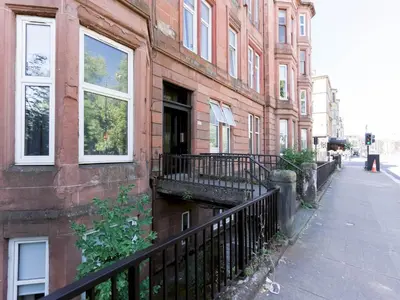 a building with a balcony on the side of a street at West End Studio Kelvingrove Park Museum - Pass the Keys in Glasgow