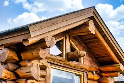 a log cabin with a window and a roof at The Log Cabins at The Vu in Bathgate