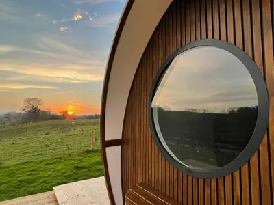 a mirror on the side of a building with a window at Endrick Escape - Luxury Glamping in Gartness