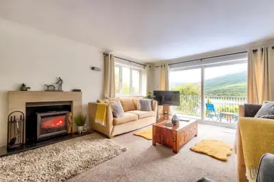 a living room with a couch and a fireplace at Braemor 4 bedroom villa, all en-suite in Arrochar