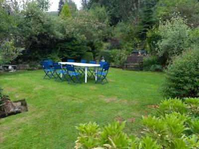 a table and chairs sitting in a yard at Braemor 4 bedroom villa, all en-suite in Arrochar