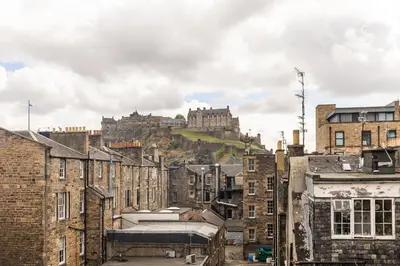 a view of a city with a castle in the background at Amazing Castle View Apartment in Edinburgh