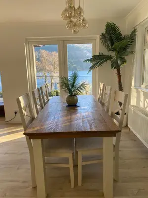 a dining room table with chairs and a potted plant on it at the waterside - carrick castle - loch goil in Carrick