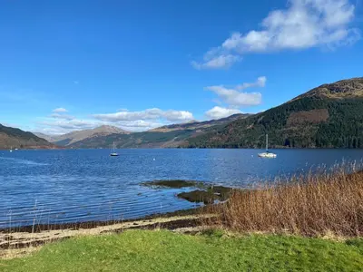 a large body of water with boats in it at the waterside - carrick castle - loch goil in Carrick