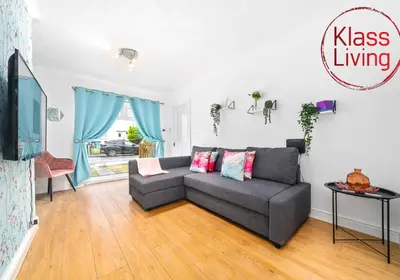 a living room with a couch and a tv at Rothesay House by Klass Living Coatbridge in Coatbridge