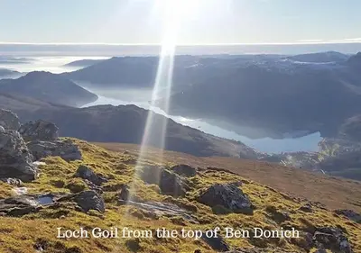 a view of the top of a mountain with the sun shining at 1 Planetree Cottage - Loch View in Lochgoilhead