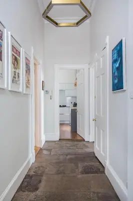 a hallway with white walls and a ceiling at Magnificent Georgian 3-Bedroom Apartment in New Town in Edinburgh