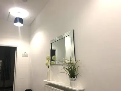 a bathroom with a mirror and a plant on a shelf at Glasgow, Bothwell, 3 bed, Suitable for Long Stays in Bothwell