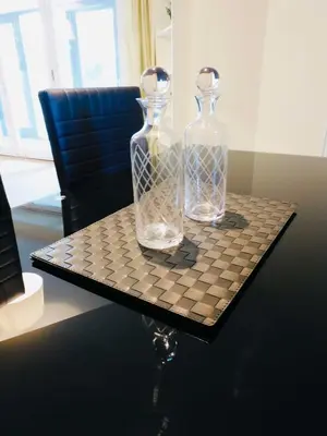 two glass bottles on a chess board on a table at No 2 - Modern 2 Bed Apartment Close to Gla Airport & M8 in Paisley