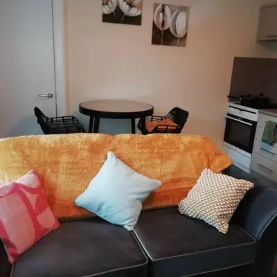a couch with pillows on it in a living room at Carvetii - Norman House - 2nd floor, 1 bedroom flat in Boʼness