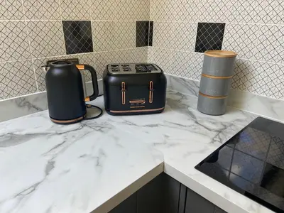 two appliances sitting on a marble counter top at Fabulous 2 Bedroom House just outside Edinburgh in Auchendinny