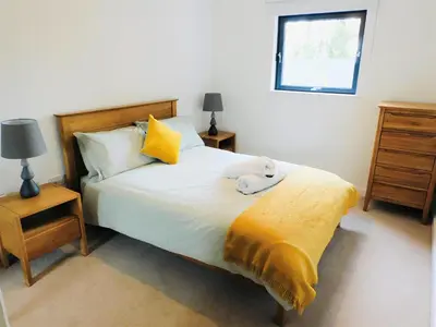 a bedroom with a bed with a teddy bear on it at Brand new gorgeous 2 bed Apt in Finnieston in Glasgow
