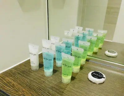 a group of bottles of moisturizers in front of a mirror at Brand new gorgeous 2 bed Apt in Finnieston in Glasgow