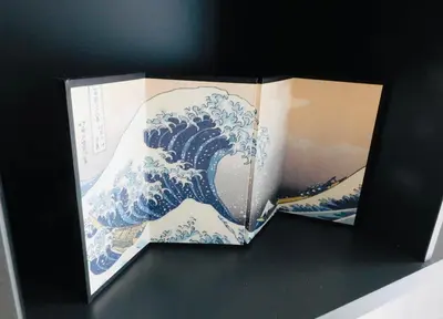 a book with a picture of the wave at Brand new gorgeous 2 bed Apt in Finnieston in Glasgow