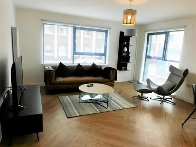 a living room with a couch and a table at Brand new gorgeous 2 bed Apt in Finnieston in Glasgow