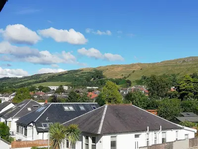 a town with houses and mountains in the background at Moorburn Heights in Largs