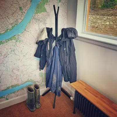 an umbrella is hanging on a wall next to boots at Laburnam Villa - Luxury 4 bedroom accommodation in the heart of Killin in Killin