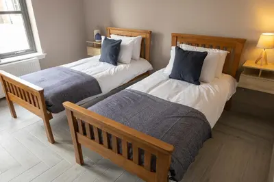 two beds in a room with two pillows at Westertonhill Newbuild Lodges with Private Hot Tub Hire Available in Balloch