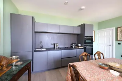 a kitchen with a table and a counter top at JOIVY Inviting Flat at the Heart of Edinburgh in Edinburgh