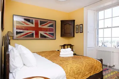 a bedroom with a bed with two pillows on it at JOIVY Inviting Flat at the Heart of Edinburgh in Edinburgh