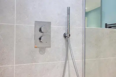 a shower in a bathroom with a glass door at JOIVY Inviting Flat at the Heart of Edinburgh in Edinburgh